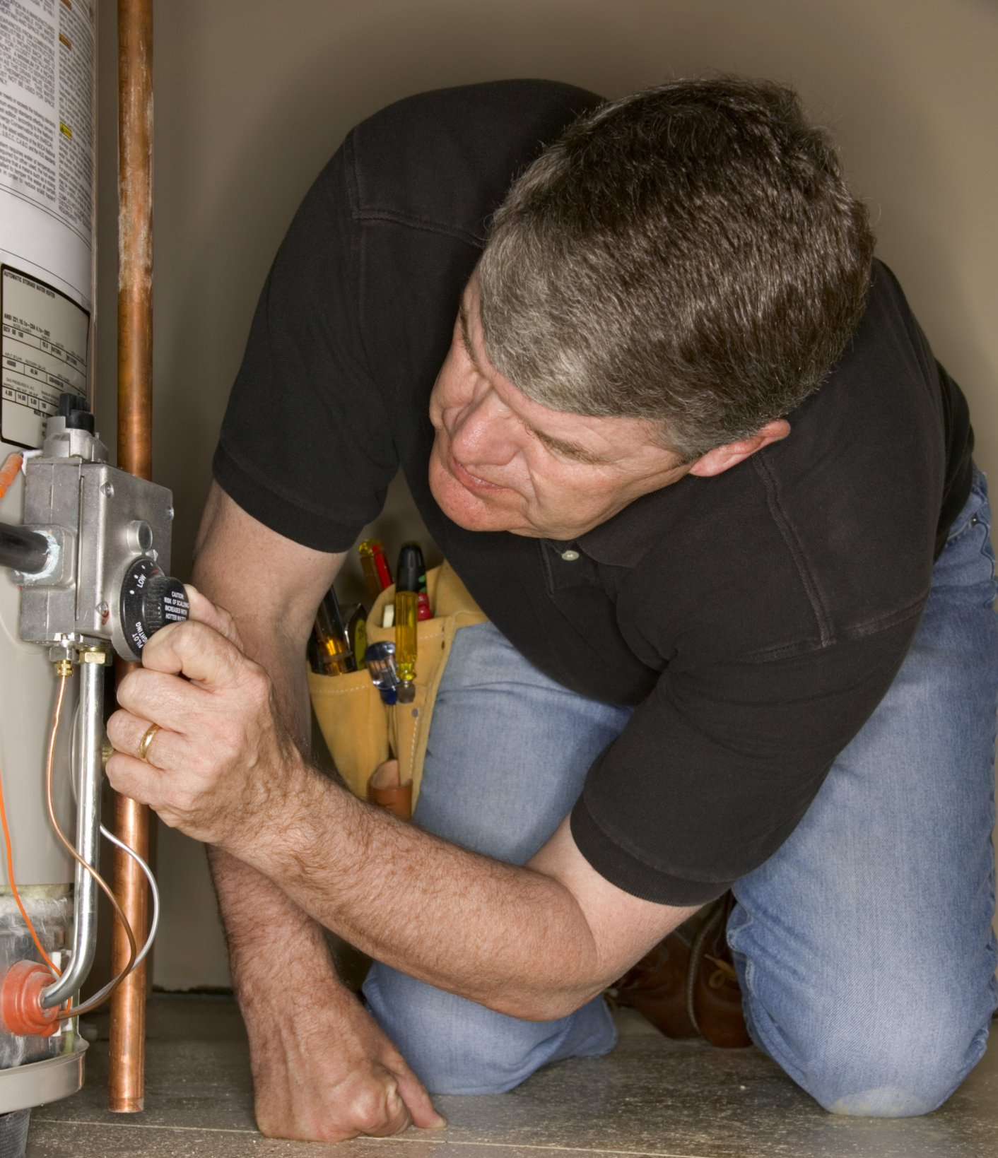Plumber inspecting water heater