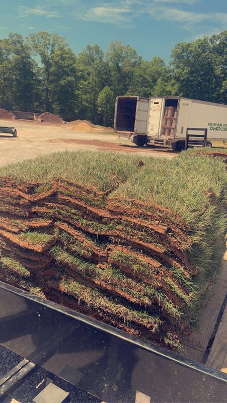 A stack of sod is sitting on top of a truck.