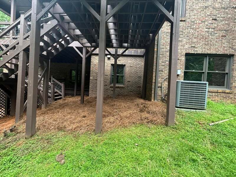 The backyard of a house with a deck and stairs.