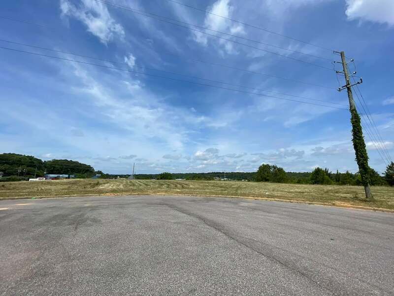 There is a telephone pole in the middle of the road.