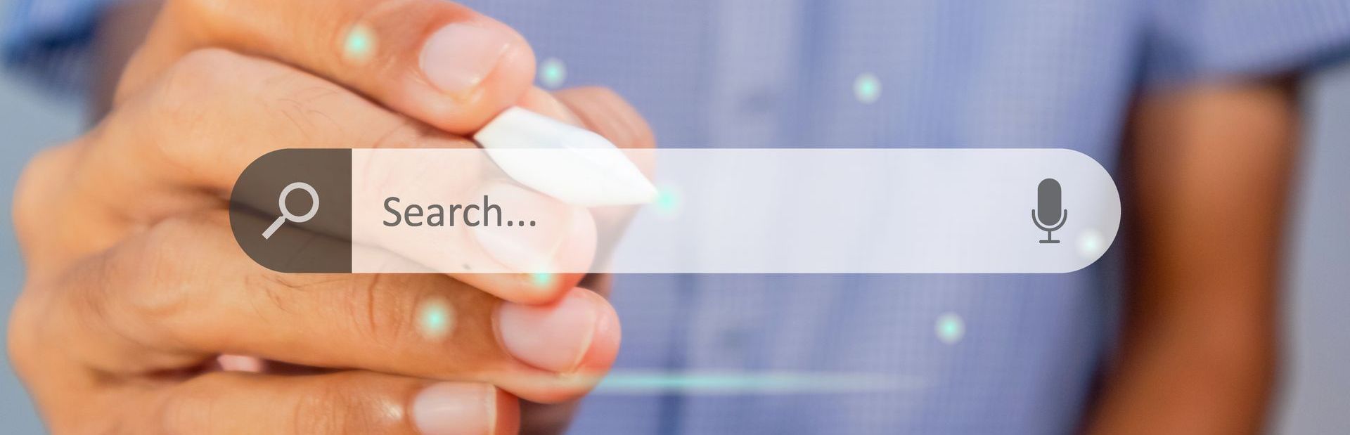 Hand pressing search bar with magnifying glass and microphone icons on a blue background