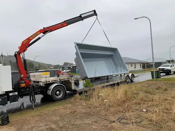 A Large Machine Lowering a New Pool Into The Ground — Solitary Island Pools In Coffs Harbour, NSW