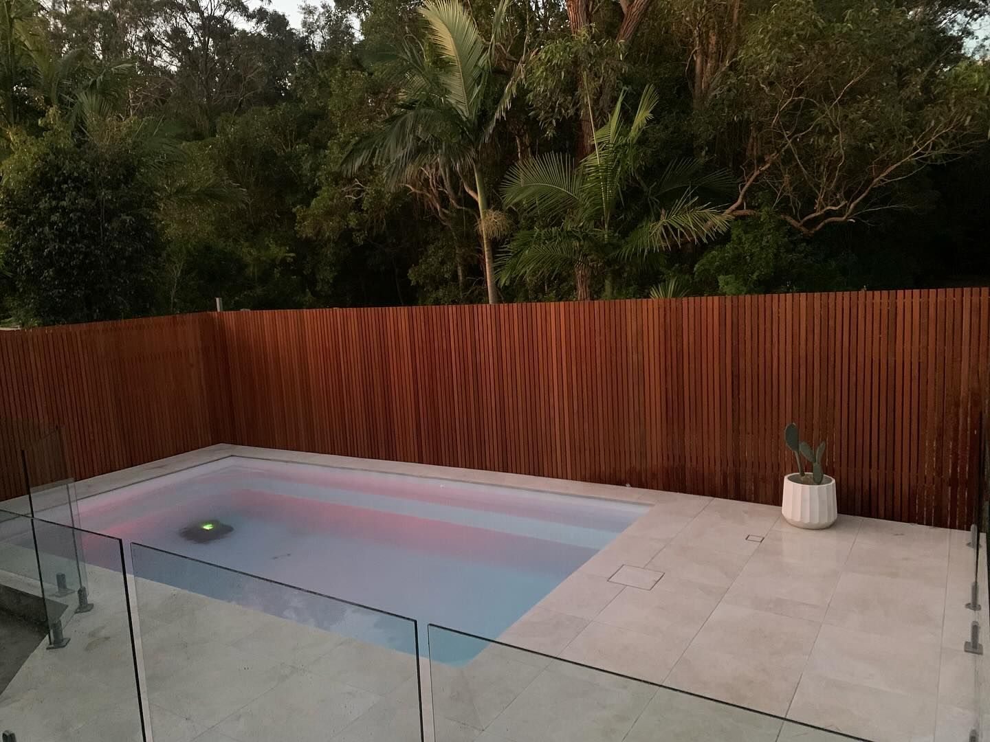 A Swimming Pool With A Wooden Fence Around It — Solitary Island Pools In Coffs Harbour, NSW