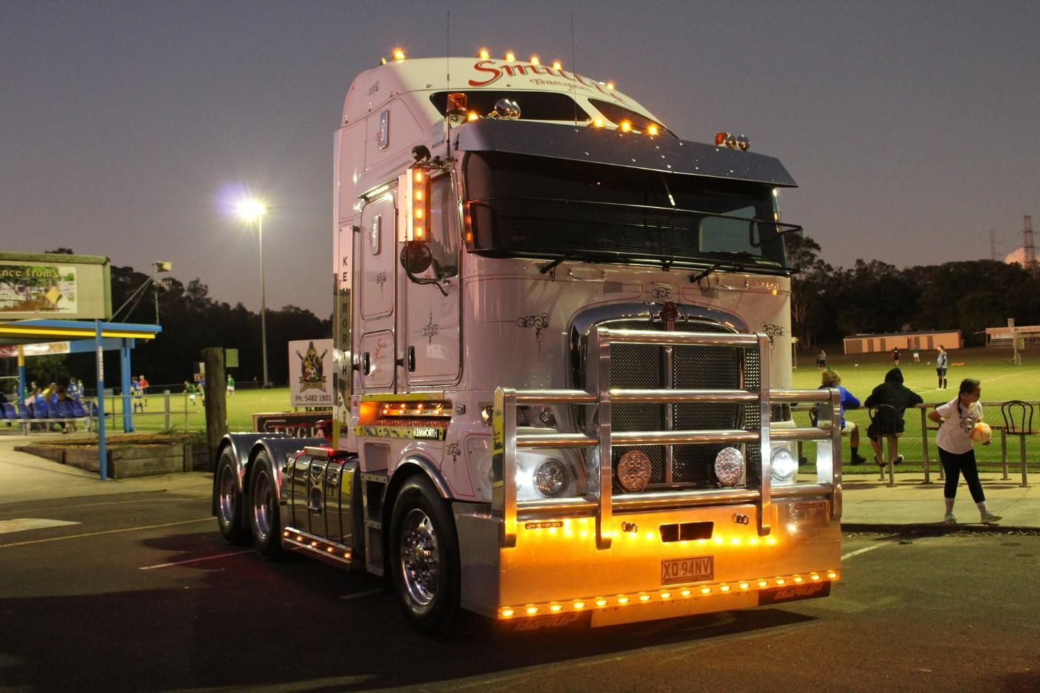A Semi Truck Is Parked in A Parking Lot at Night — Smillie Transport Pty Ltd in Brisbane, QLD