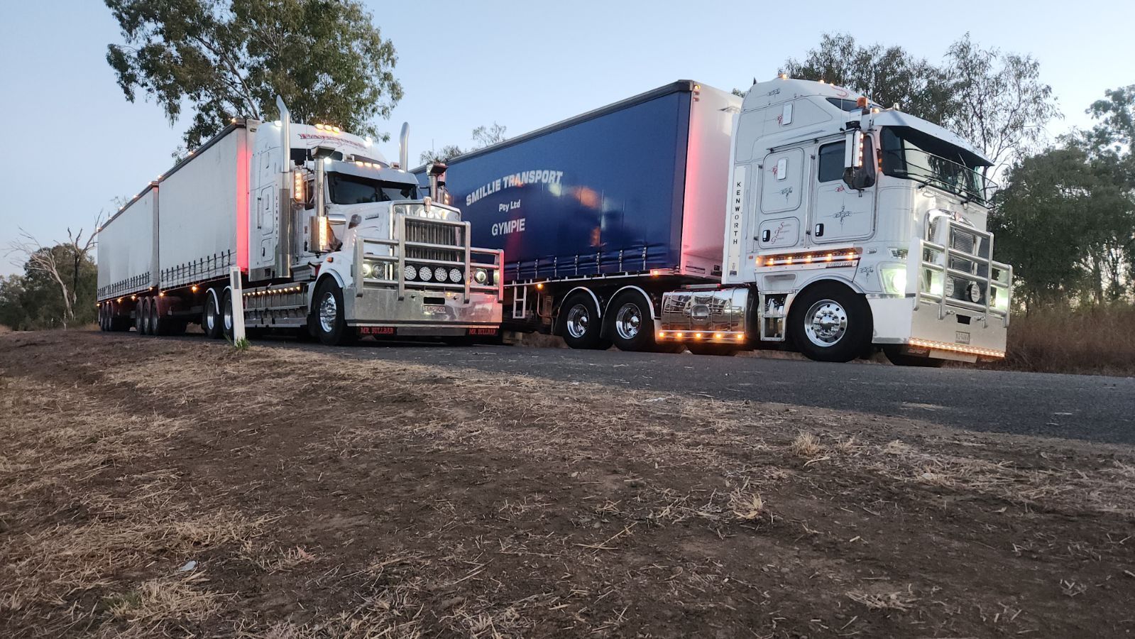 A White Semi Truck with A Red Container on The Back — Smillie Transport Pty Ltd in Brisbane, QLD
