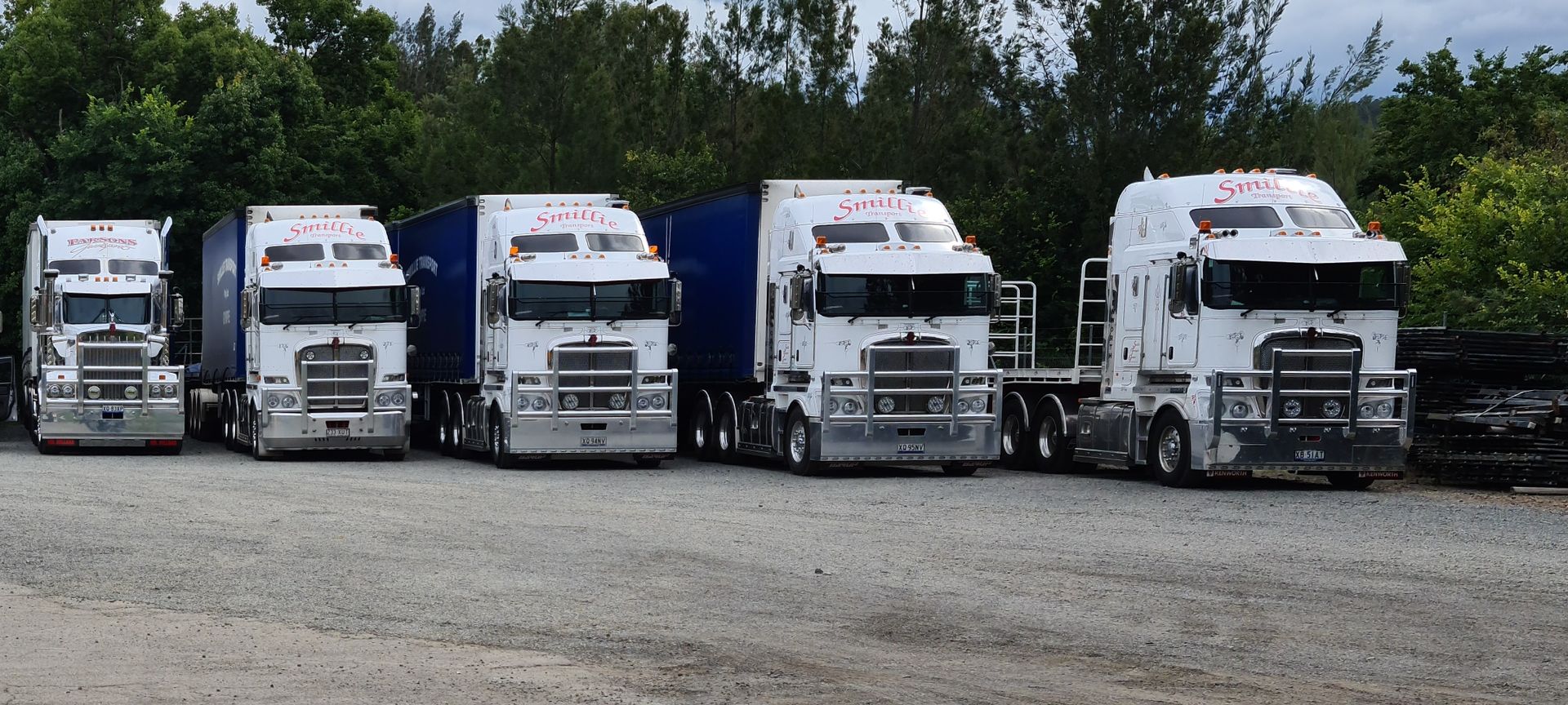 A Man Is Pushing a Forklift Into a Semi Truck — Smillie Transport Pty Ltd in Two Mile, QLD