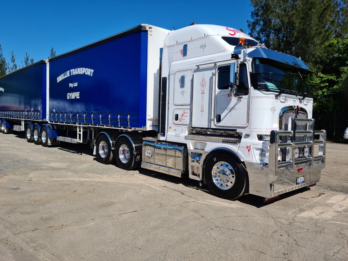 A Row of Red Semi Trucks Parked Next to Each Other in A Parking Lot — Smillie Transport Pty Ltd in Toowoomba, QLD