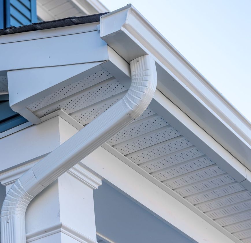 A white gutter on the side of a house