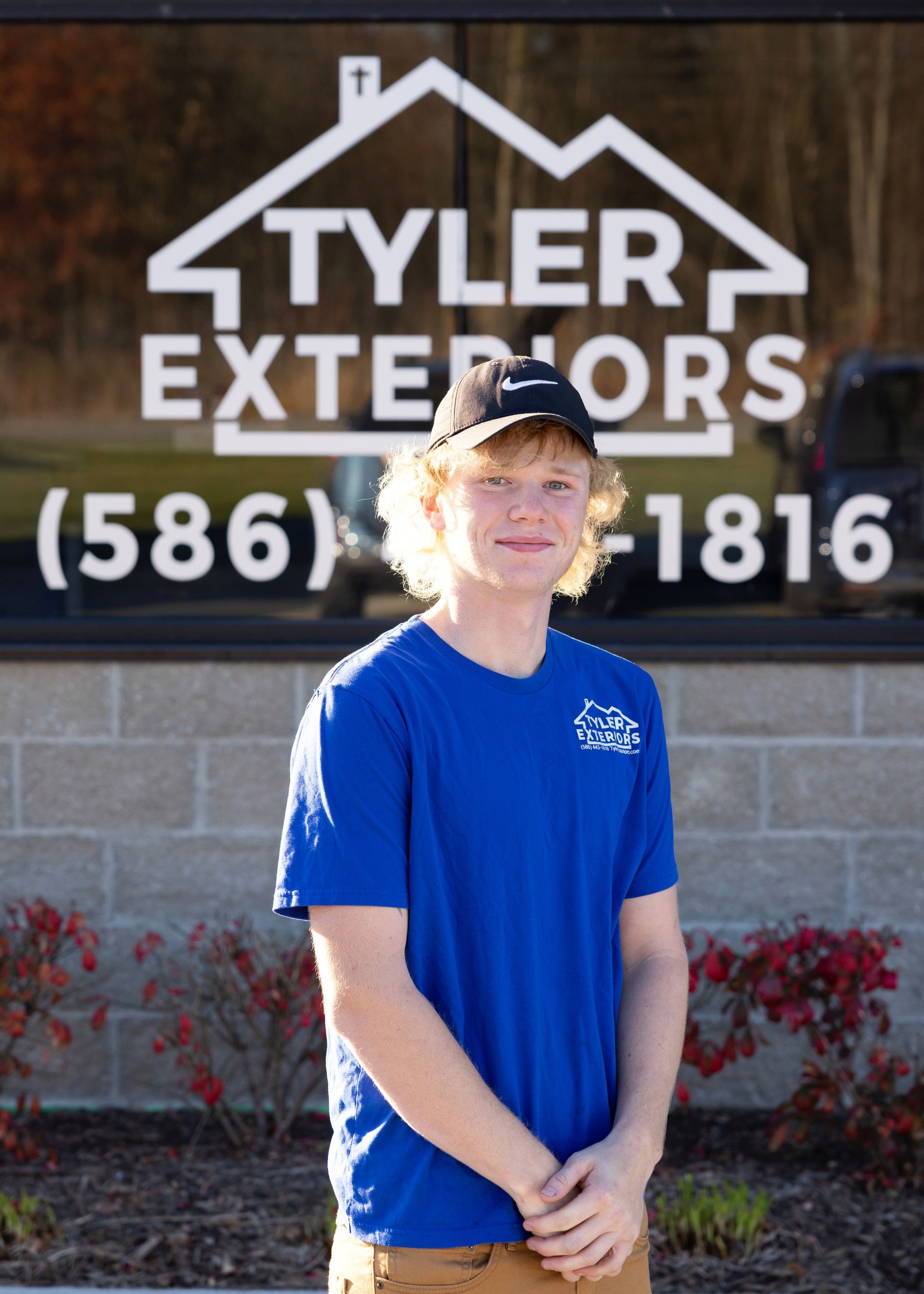 Young man in blue shirt in front of 