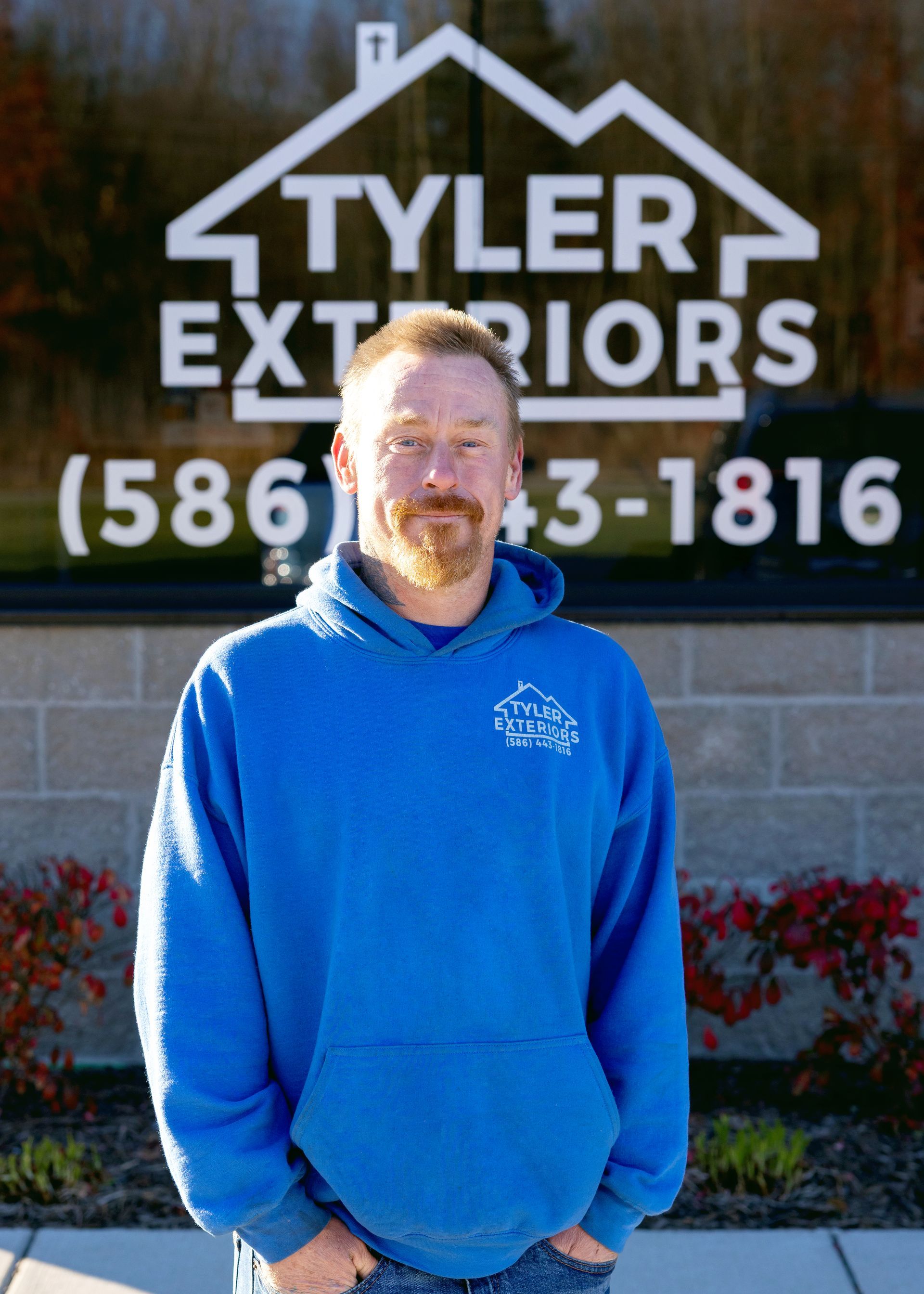 Man in blue sweatshirt in front of 