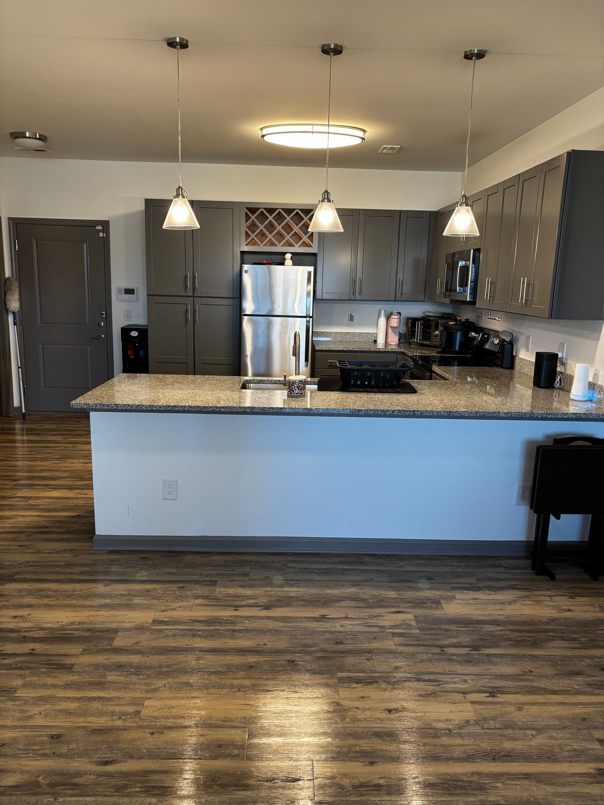 A kitchen with stainless steel appliances and granite counter tops.