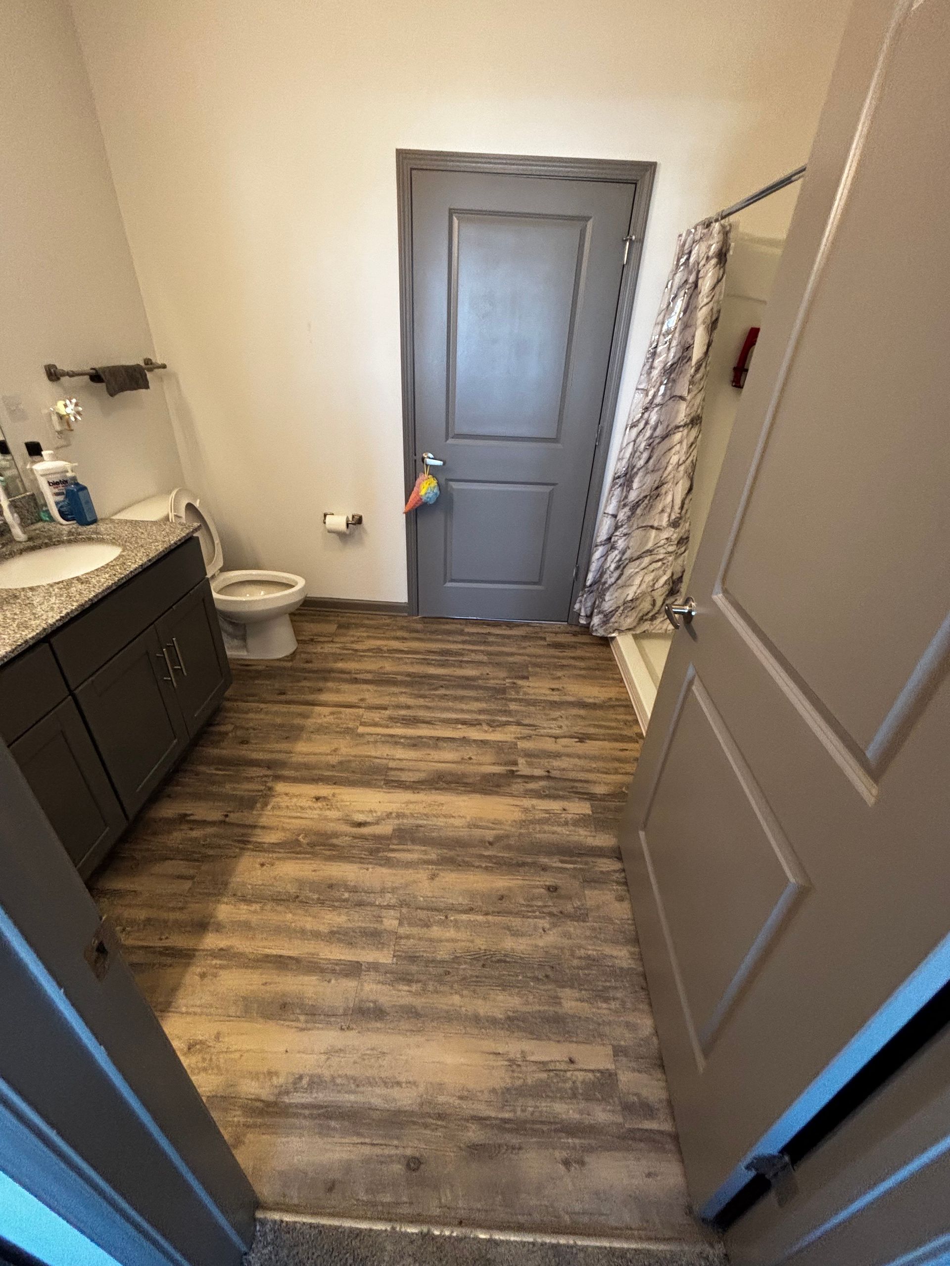 A bathroom with a toilet , sink , and shower.
