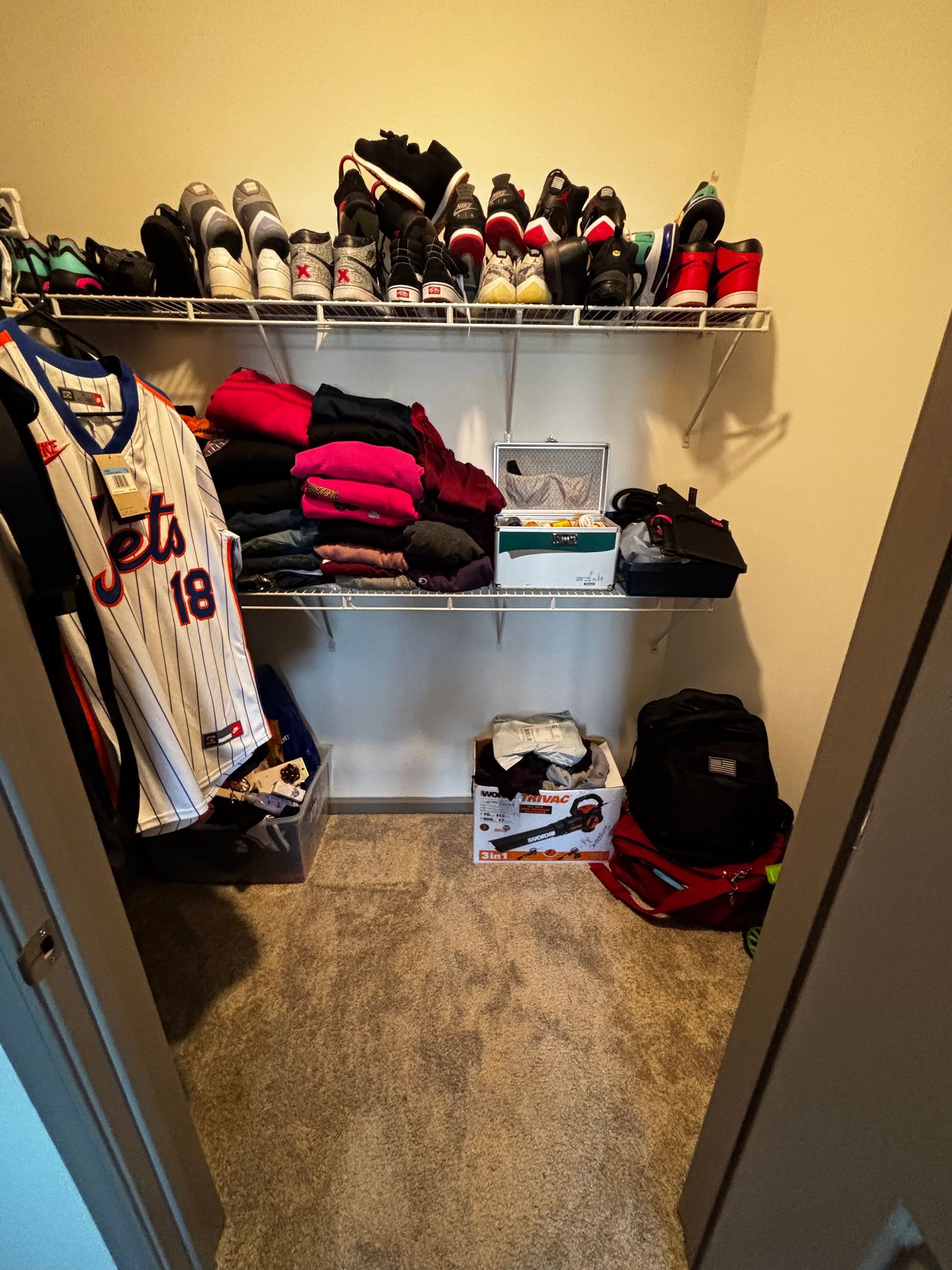 A closet with a jersey that says jets 18 on it