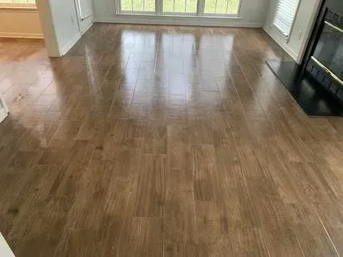 A living room with hardwood floors and a fireplace.