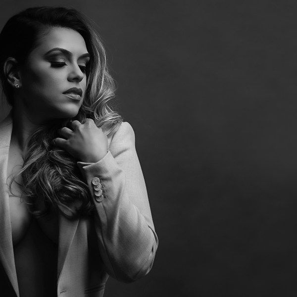 A black and white photo of a woman wearing a white jacket.