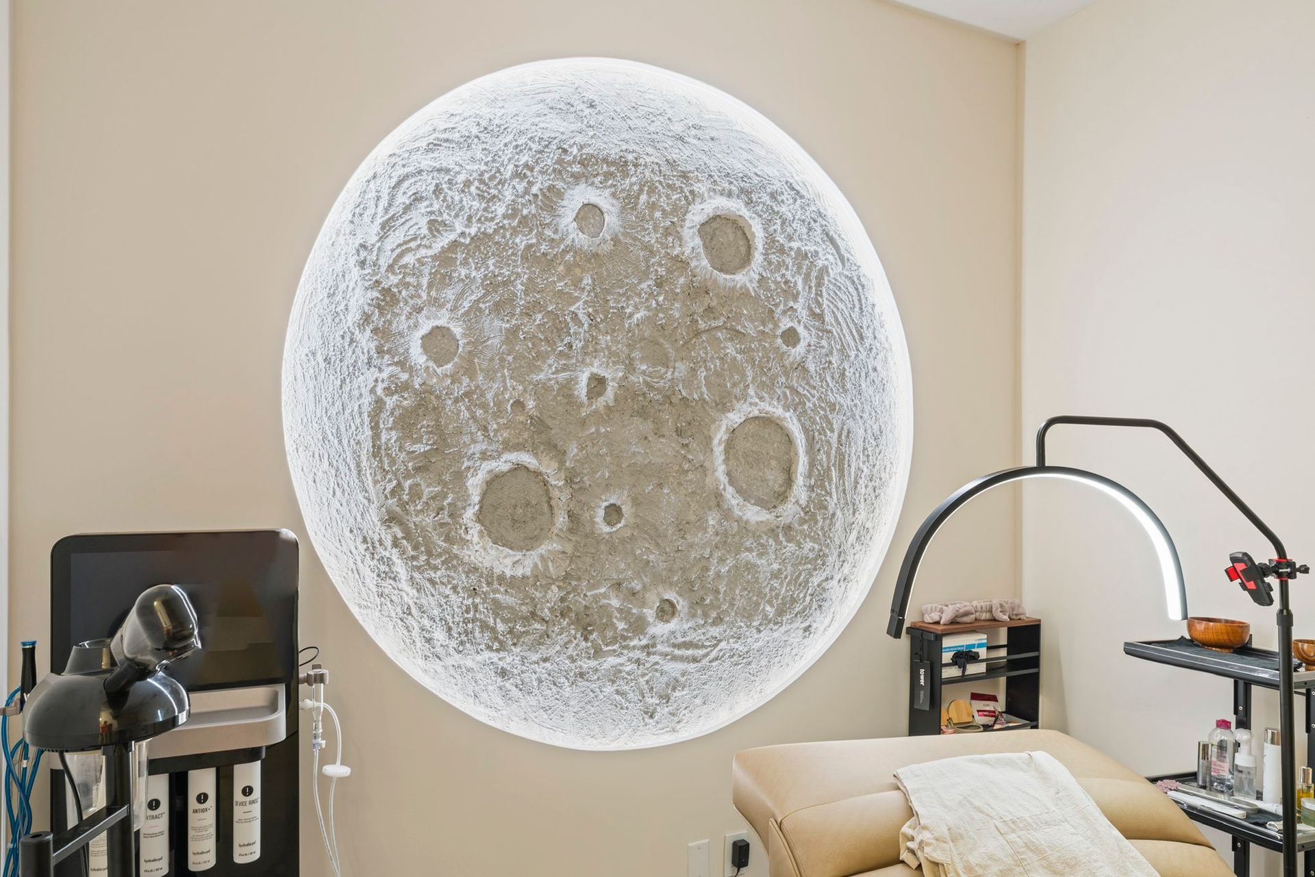 A room with a picture of the moon on the wall