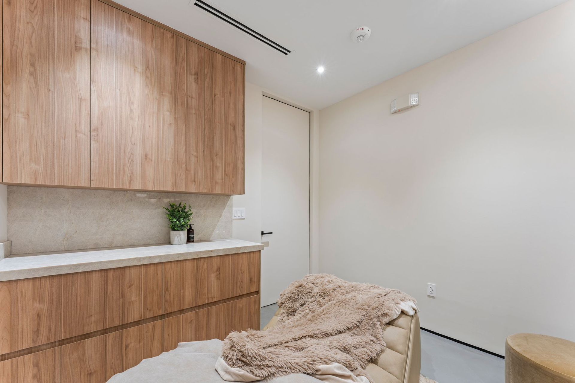 There is a chair in the middle of the room with a blanket on it.