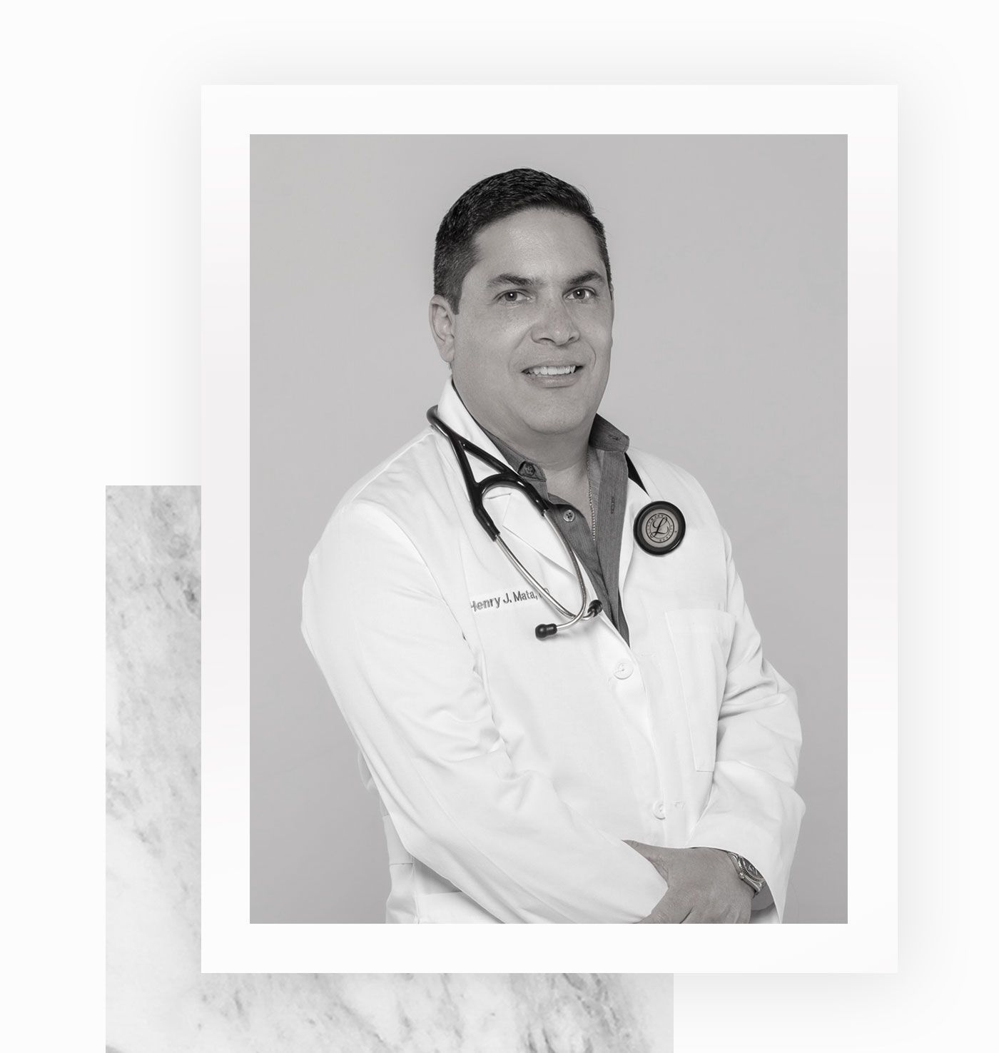 A black and white photo of a doctor with a stethoscope around his neck.