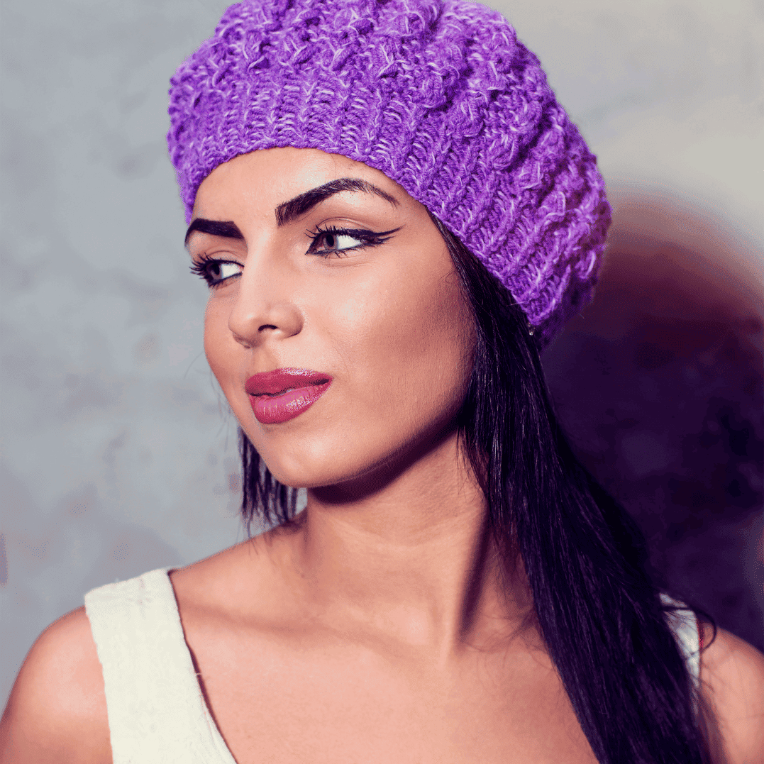 Data Architecture Recruitment specialist wearing a purple knit beanie and white top, looking to the side against a grey background