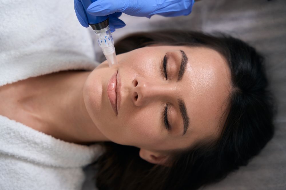 A woman is getting a botox injection in her face.