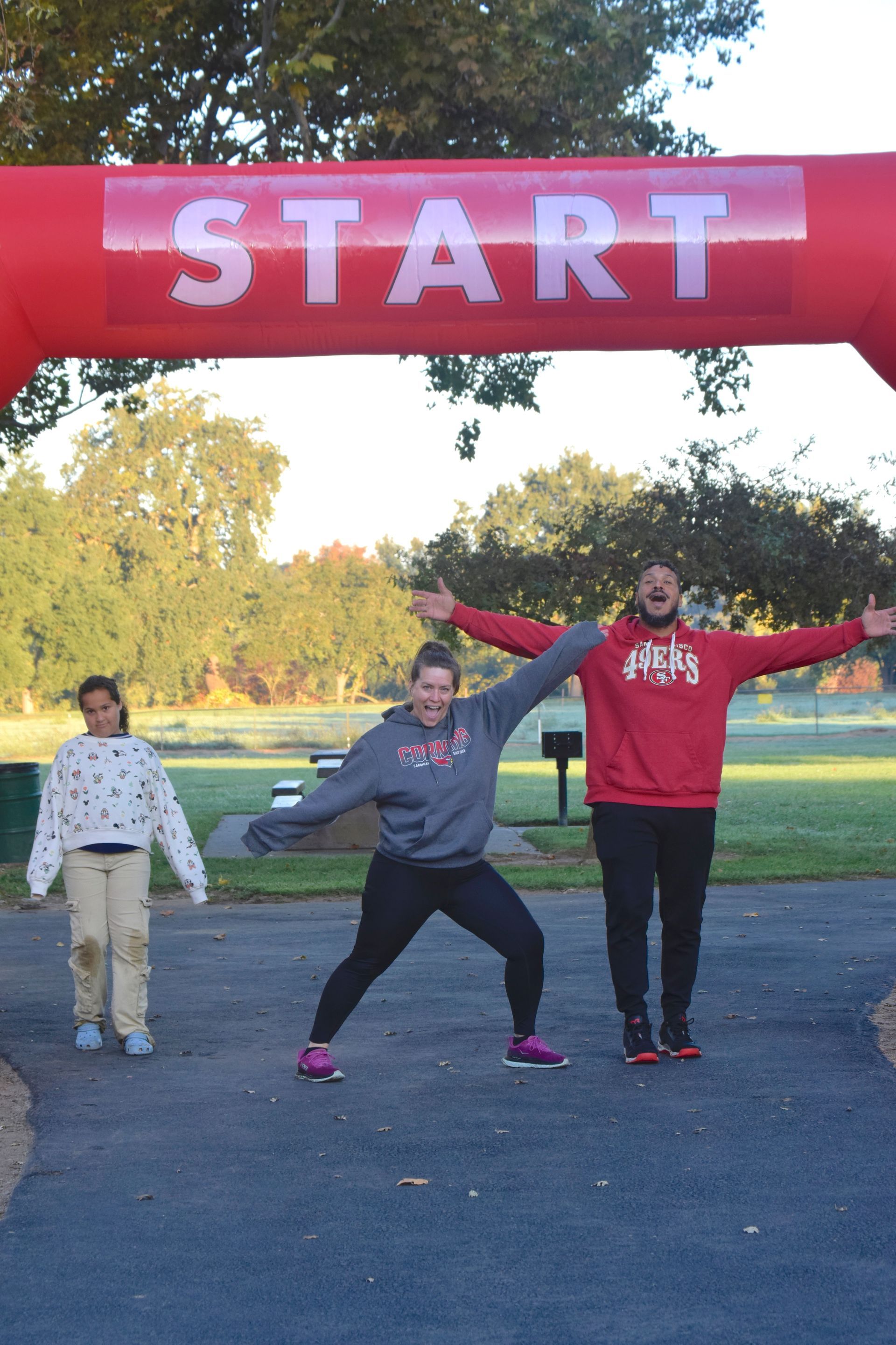 People posing under a red 