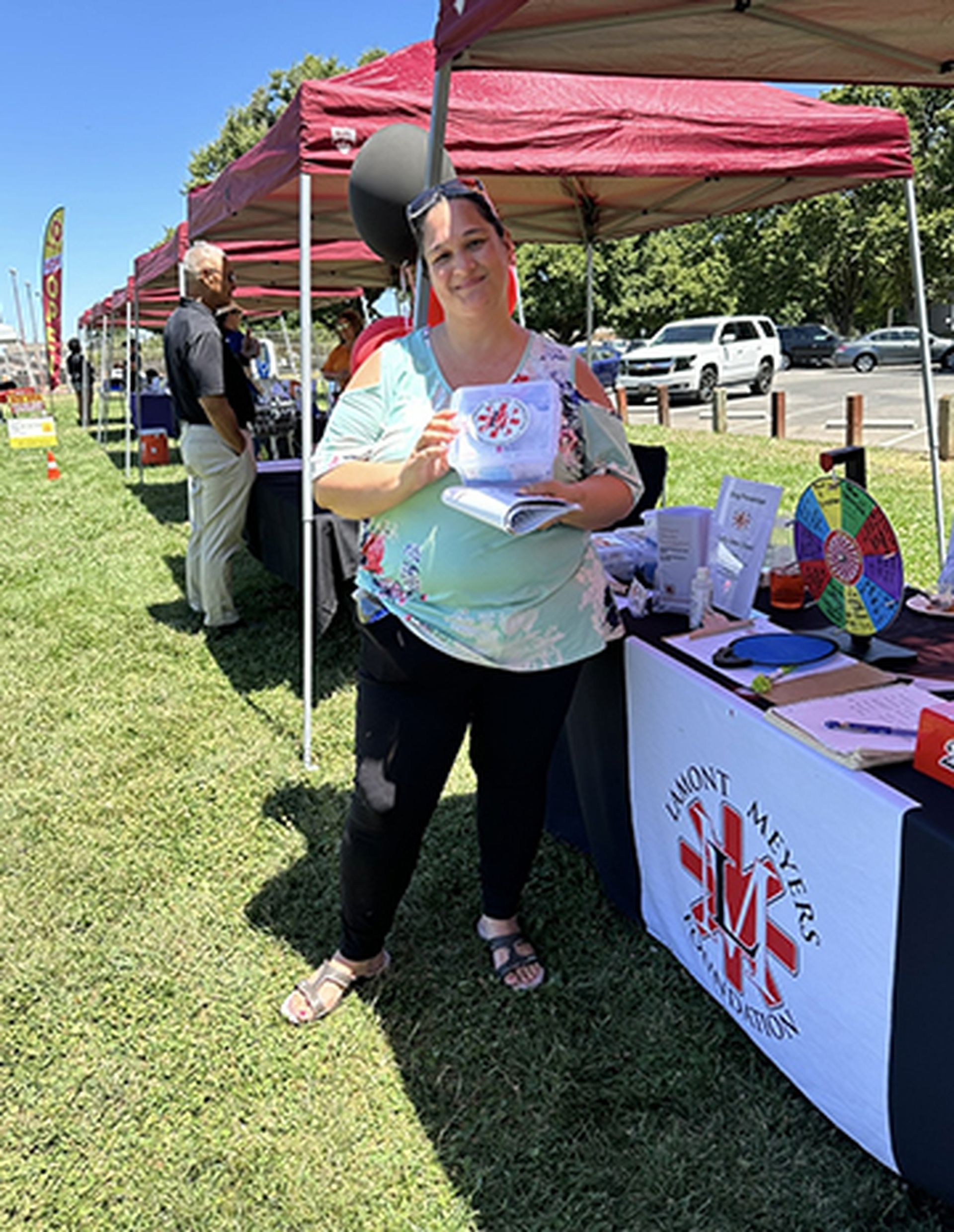 A woman is standing in front of a table that says emergency medical services