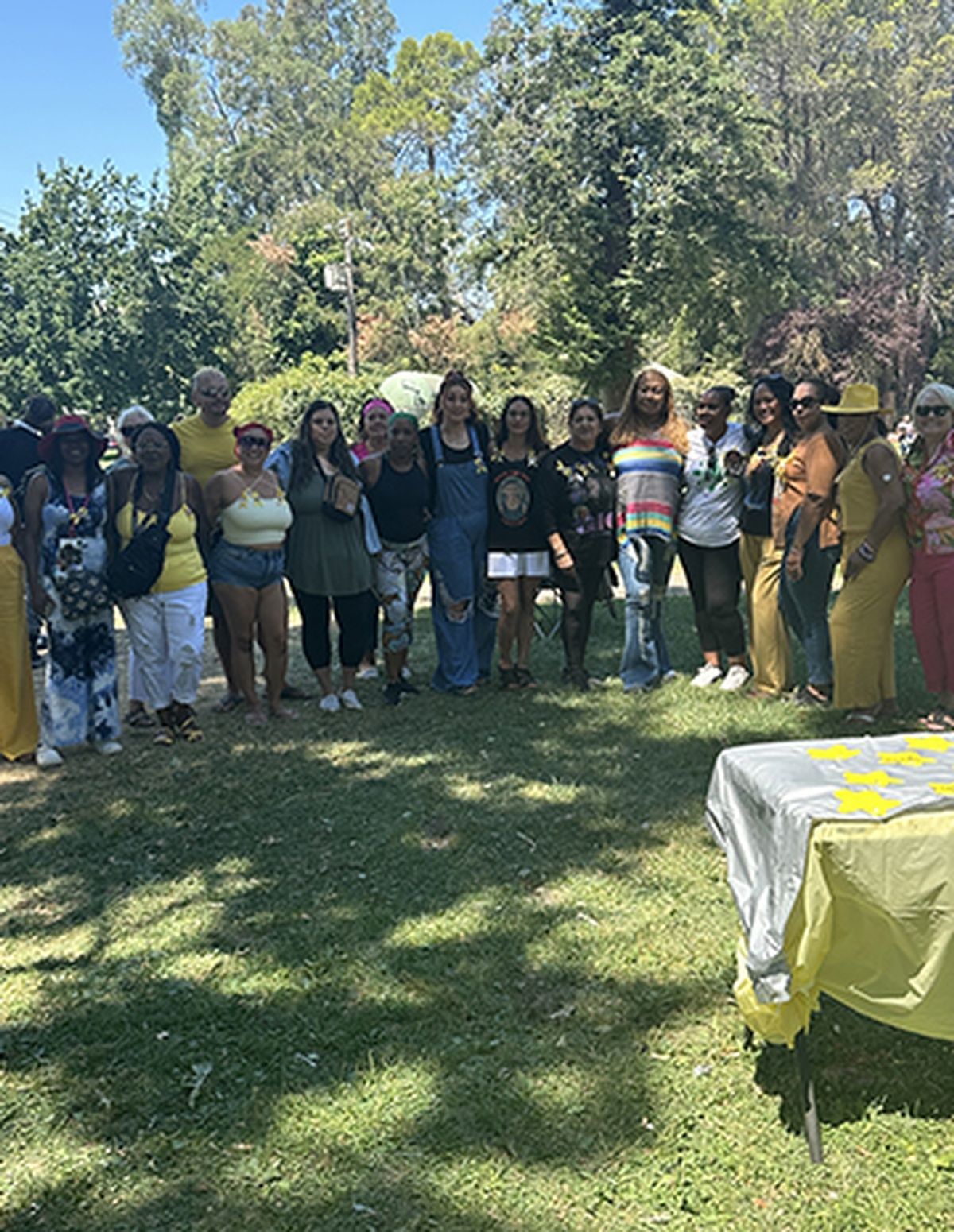 A group of women are posing for a picture in a park.