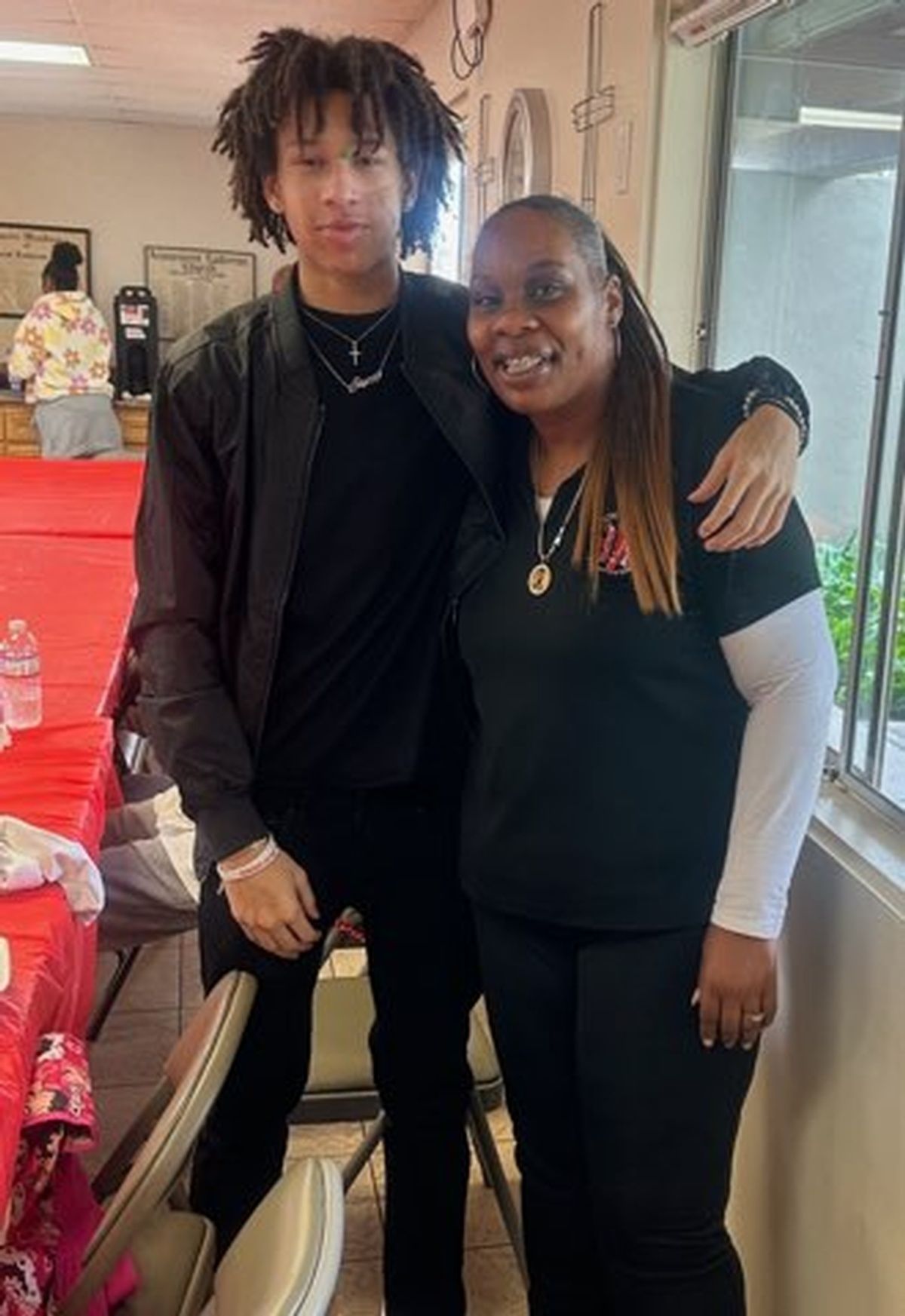 A man and a woman are posing for a picture in a room.