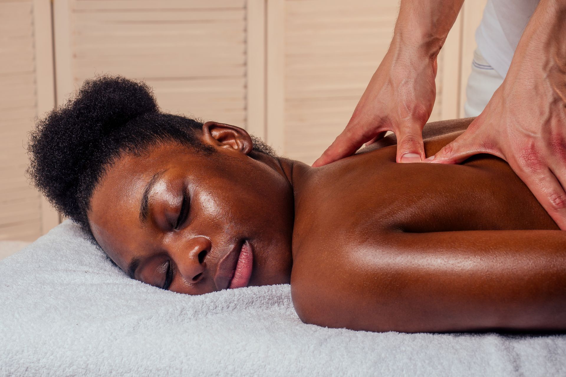 A woman is laying on a massage table getting a massage.