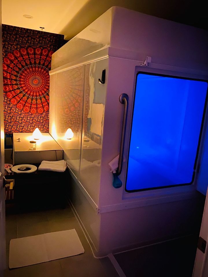 A bathroom with a bathtub and a blue window