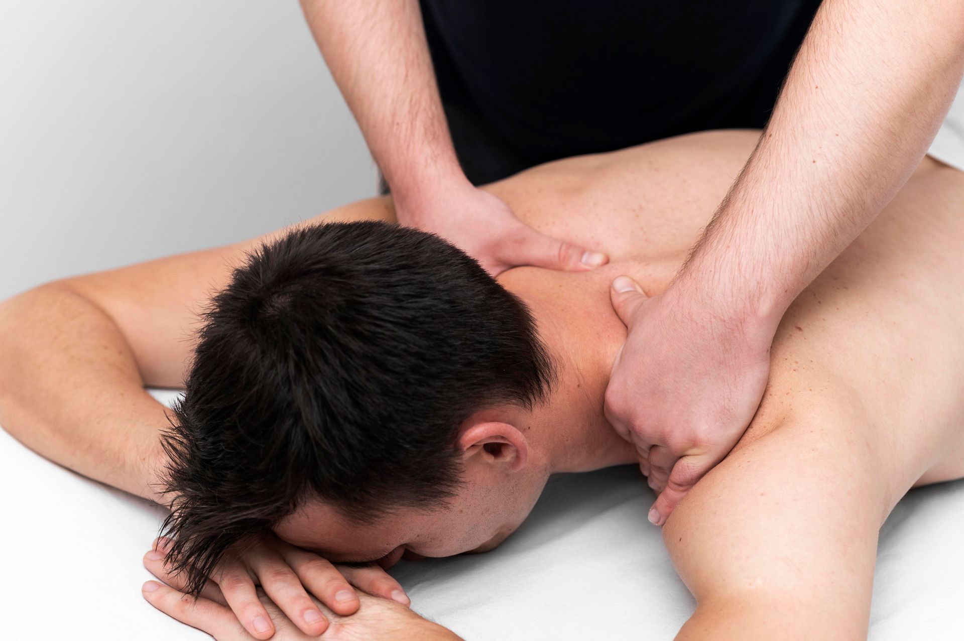 a man getting his shoulder massaged