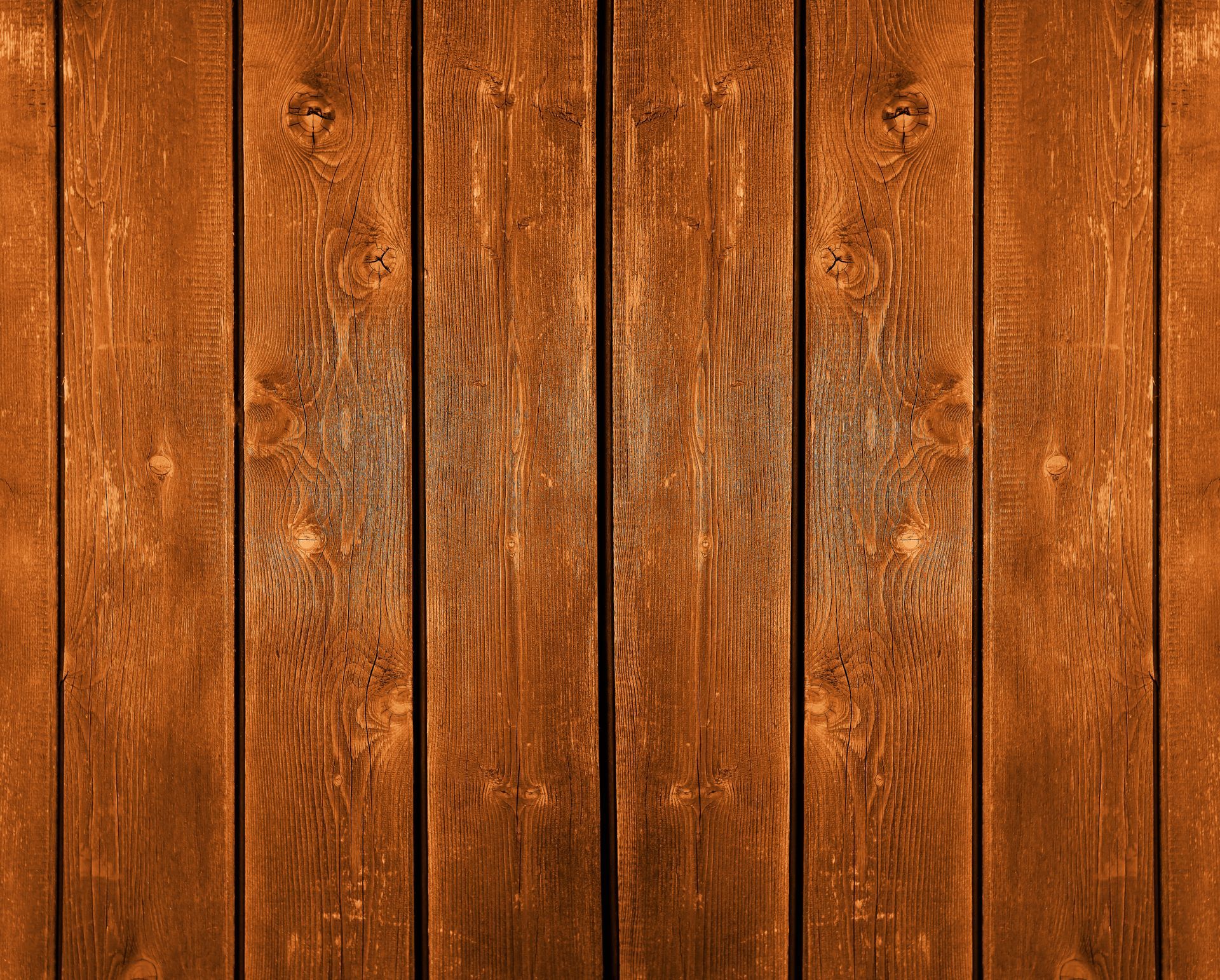 Brown wooden planks, vertical grain, textured surface.