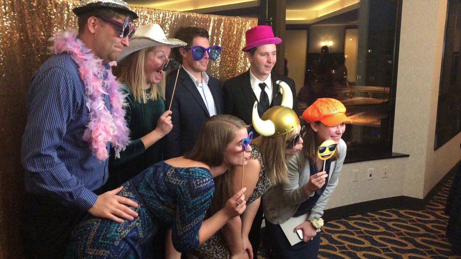 a group of people are posing for a picture in a photo booth