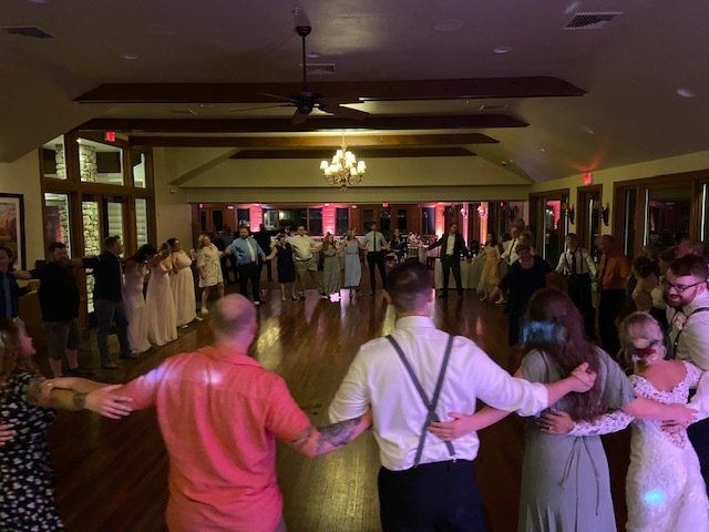 Wedding guests in a circle during the last song at Gordon Lodge in Baileys Harbor Wisconsin with Sound Sensations Ent