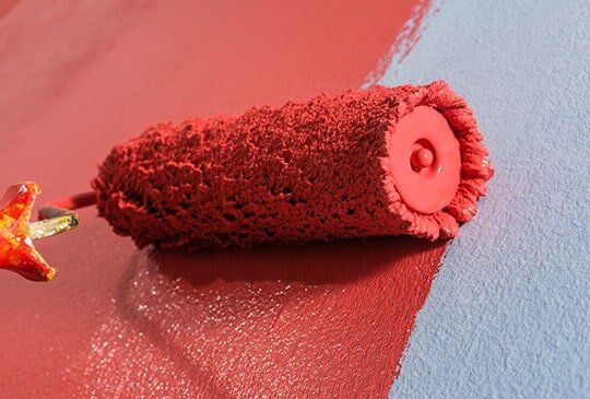 Roller painting in red — Wix Painting Service in Mackay, QLD