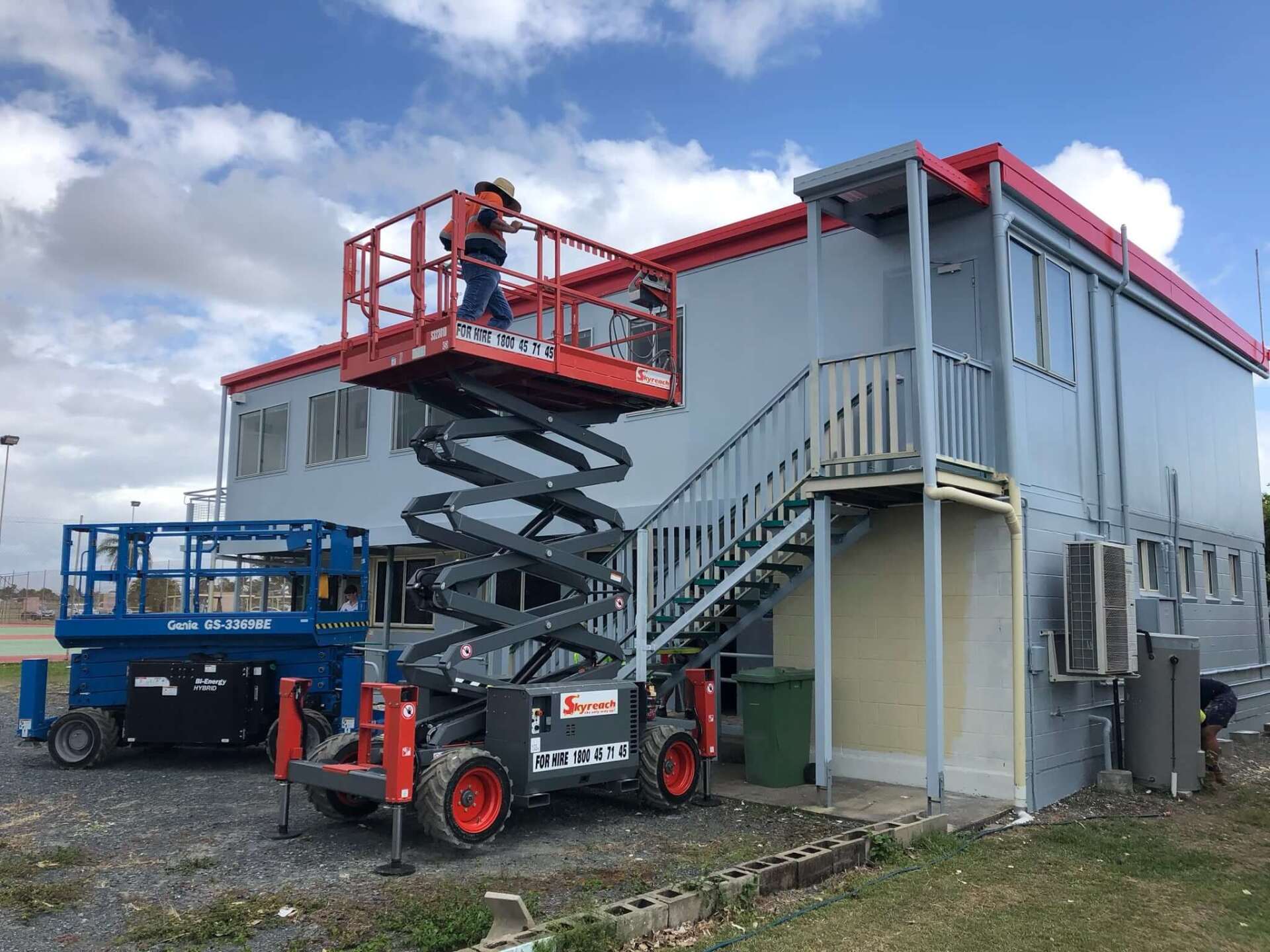 using scissor lift to paint outside of multi level building