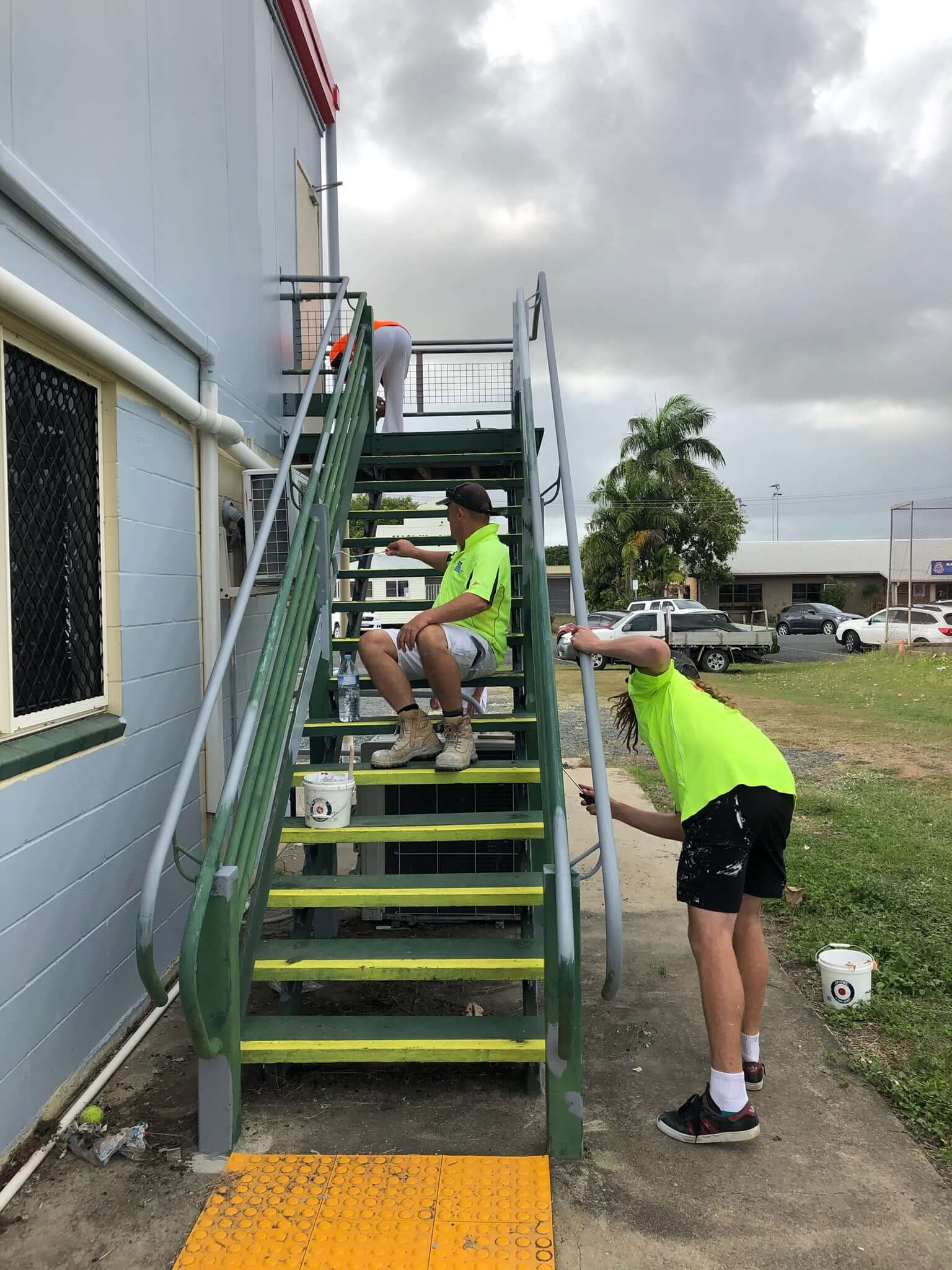 team painting stair well