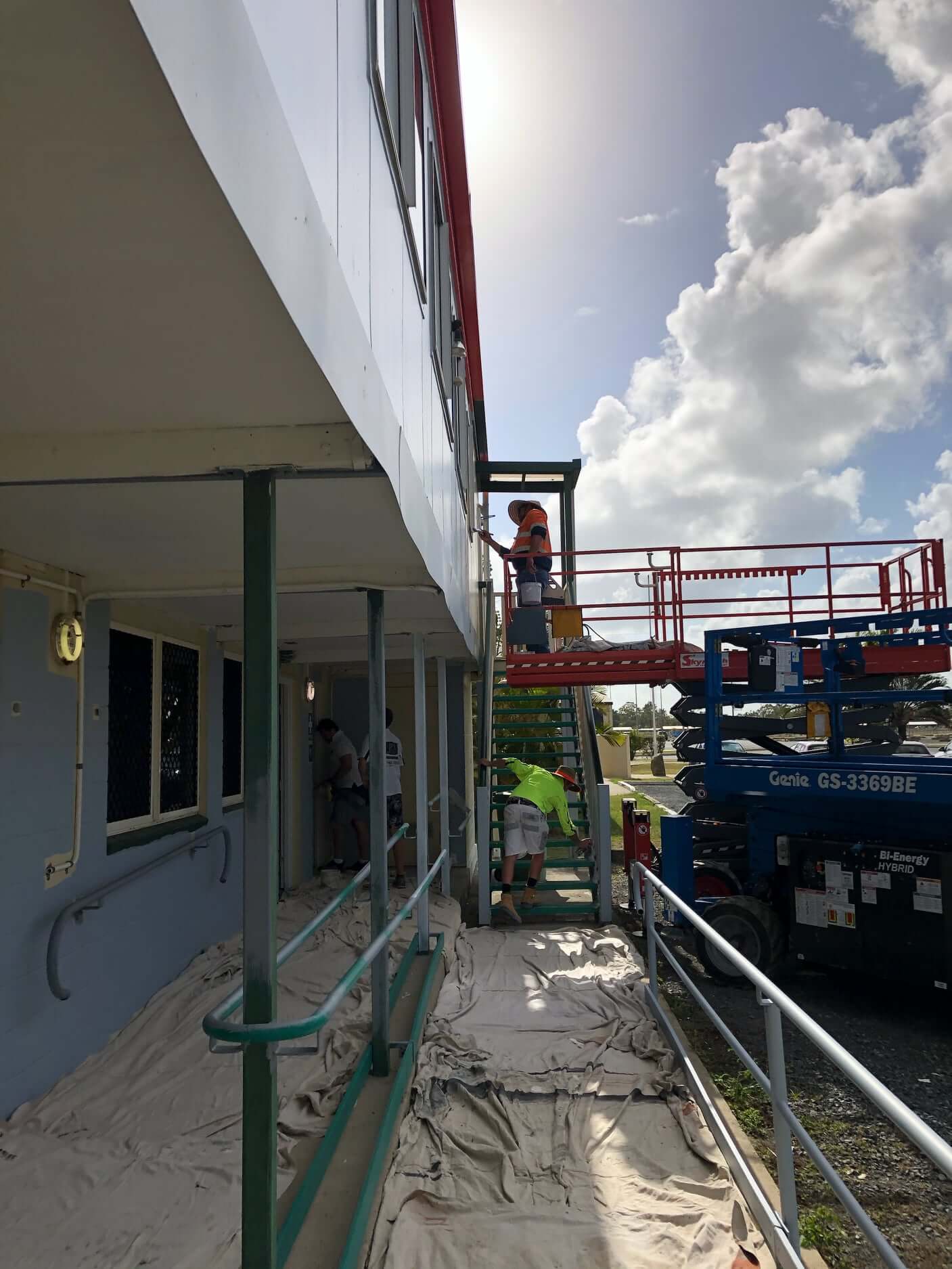 team painting commercial building