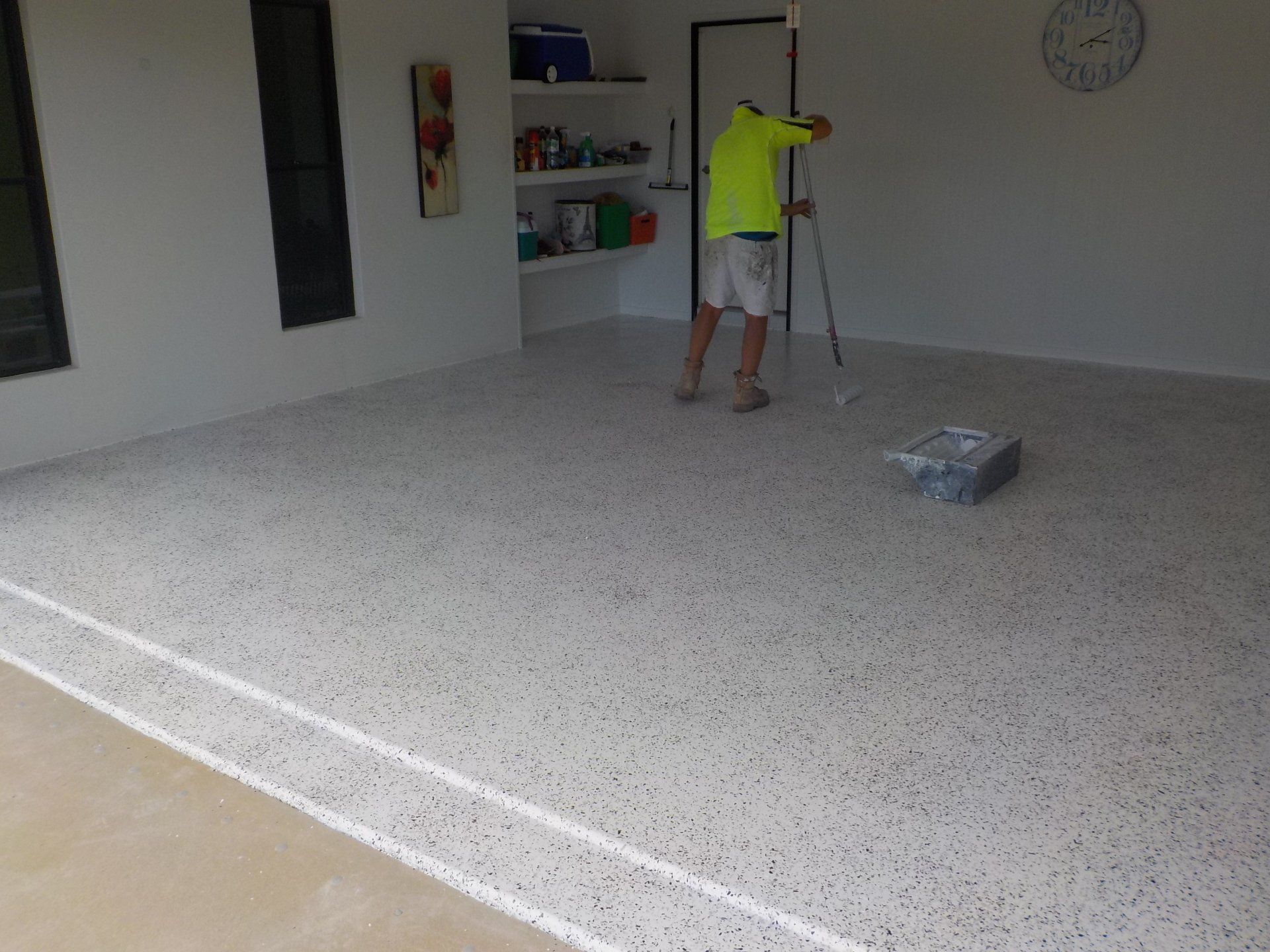 team installing flake flooring in residential garage