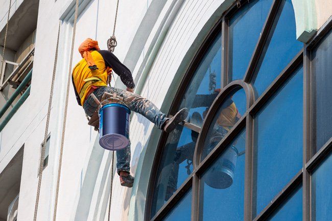 Man Painting A Commercial Building