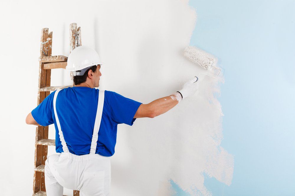 Painter Painting A Wall - Painting Services in North Mackay, QLD