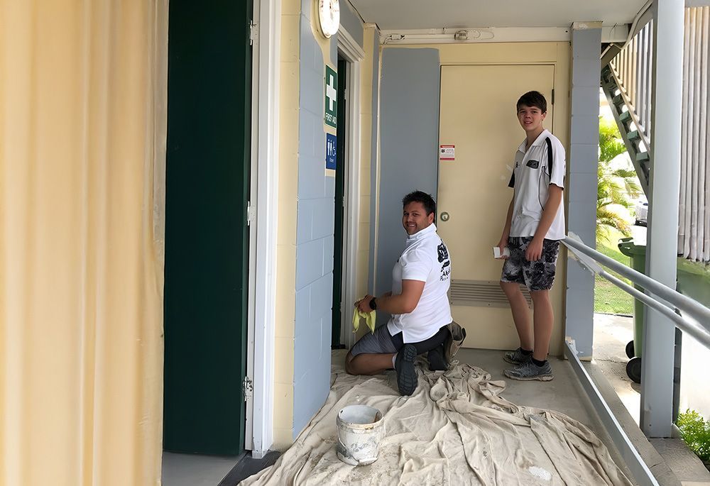 Two People Painting Hallway Wall