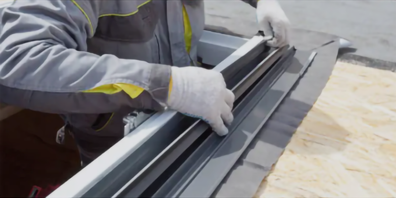 A rope is hanging from the side of a building.