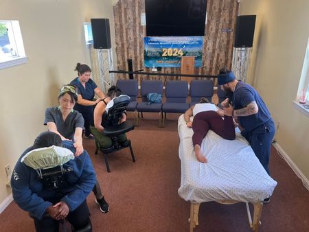 A group of people are getting massages in a room.