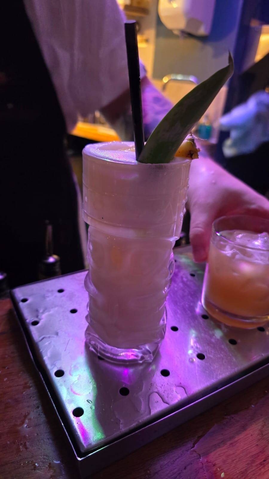 A close up of a cocktail on a tray on a table.