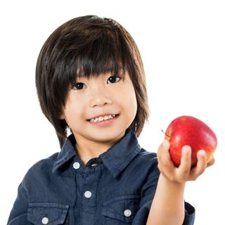 Boy Holding An Apple - Orthodontics in West Berlin, NJ