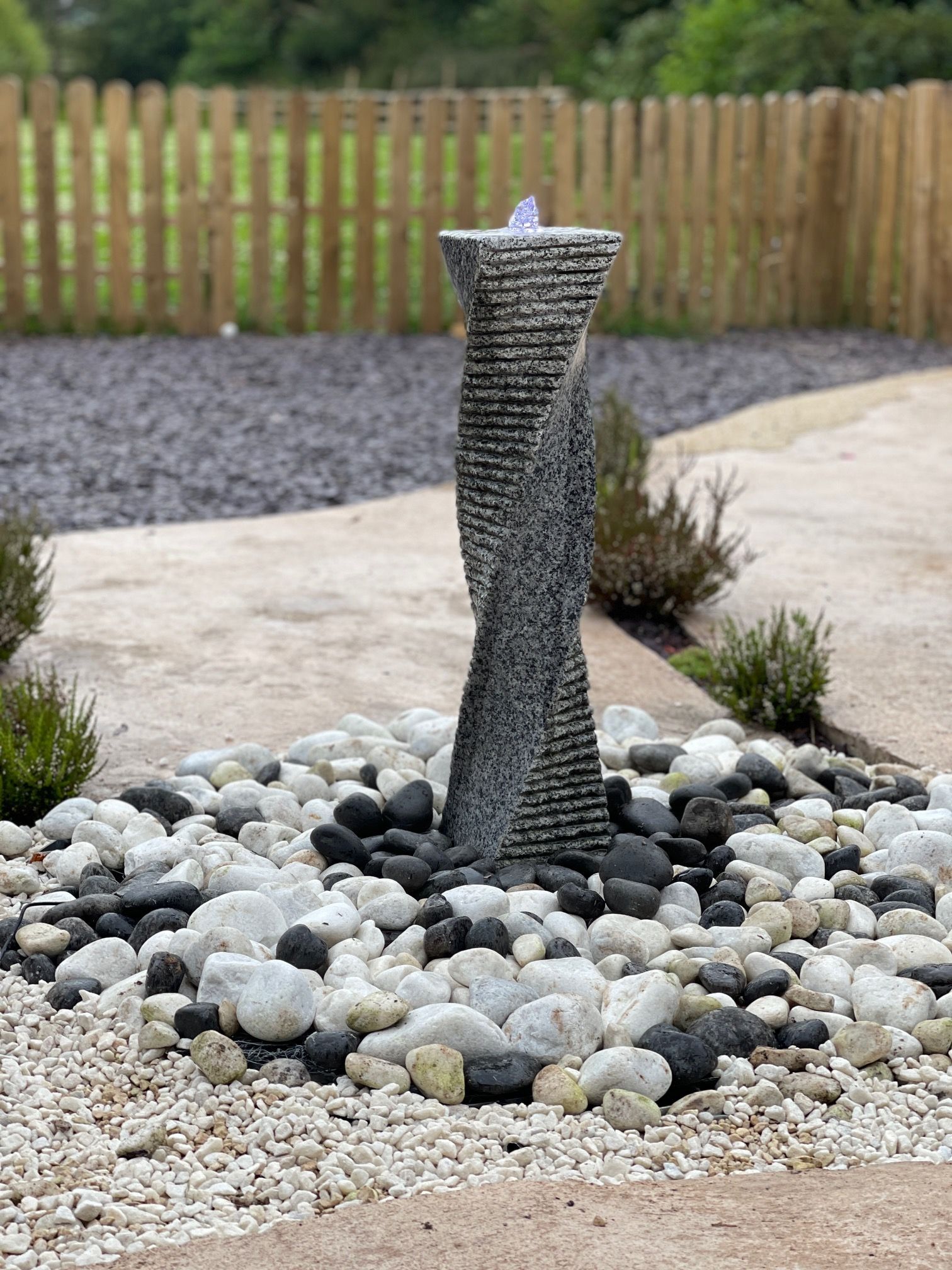 Twisting spiral granite tower column water feature