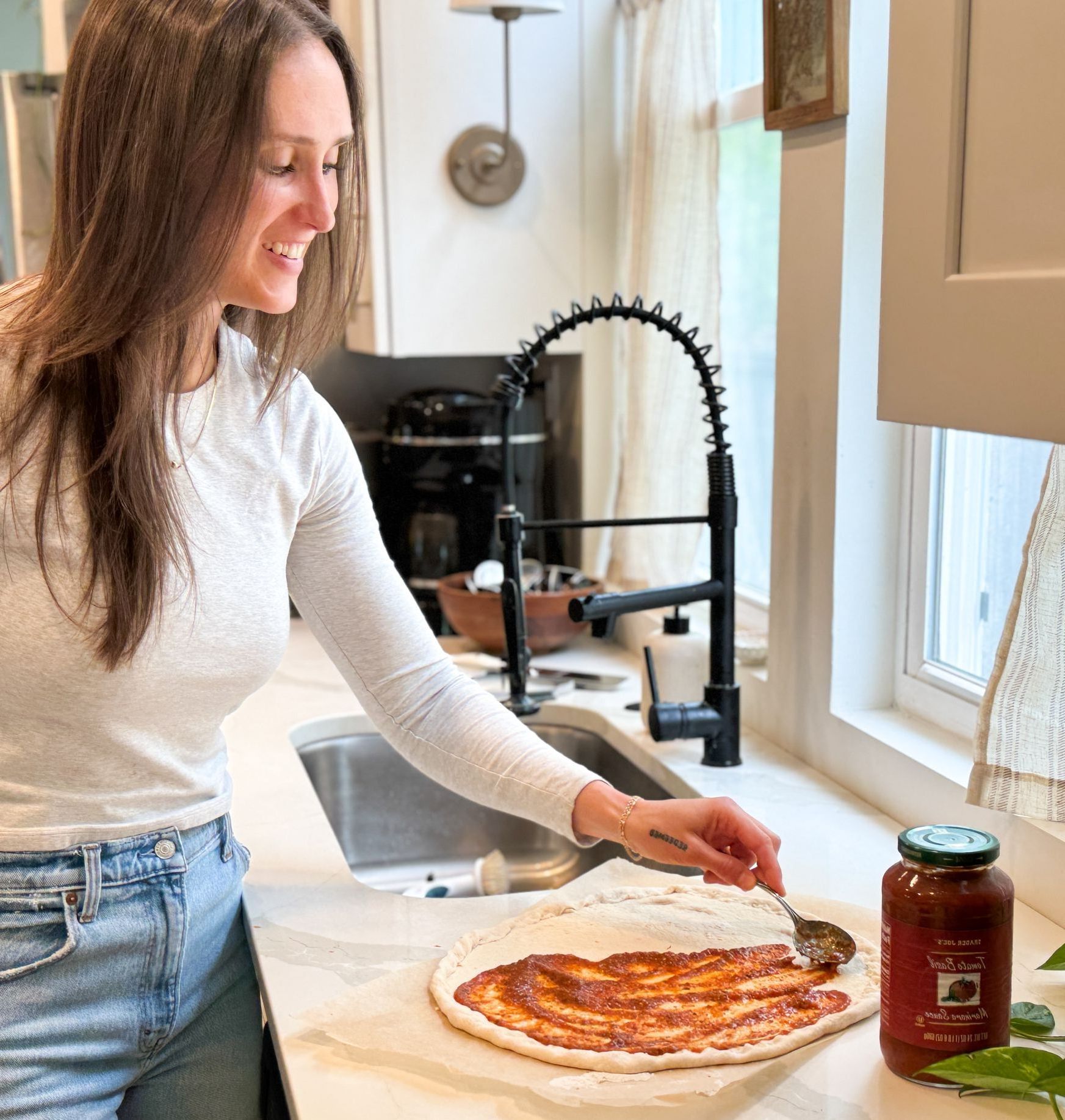 Jourdan prepares a healthy, wholesome snack in her client's bright kitchen.
