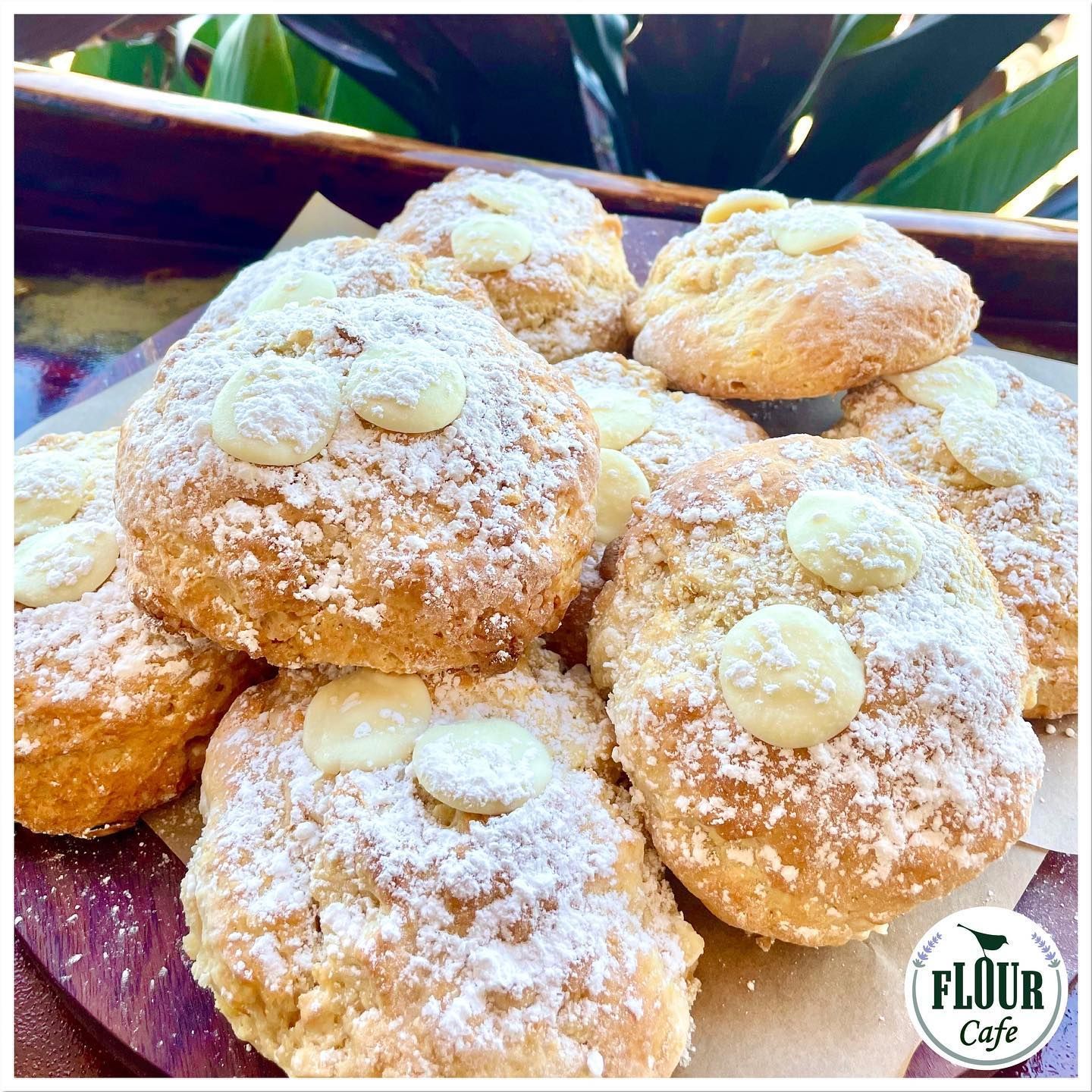 A Pile of Golden-brown Scones Topped With White Chocolate and Powdered Sugar — Flour in Yeppoon, QLD