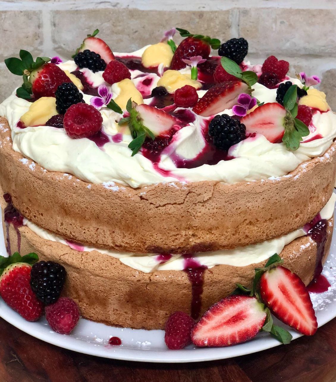 A Two-layer Sponge Cake With White Cream, Berries, and Sauce, on a White Plate — Flour in Yeppoon, QLD